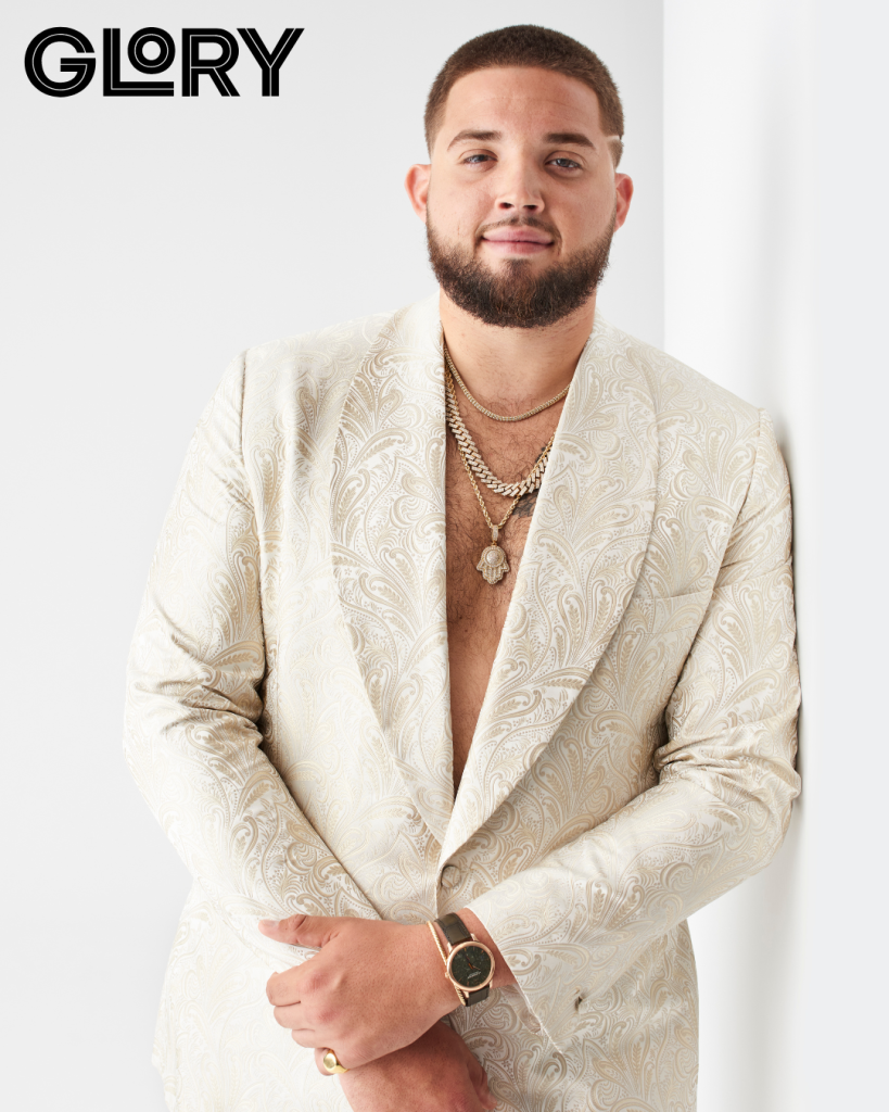 Alek Manoah wearing white jacket and chains with no shirt underneath