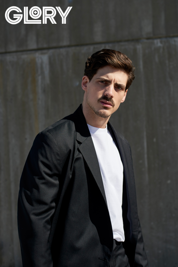 Paul Poirier in black suit jacket with white tee