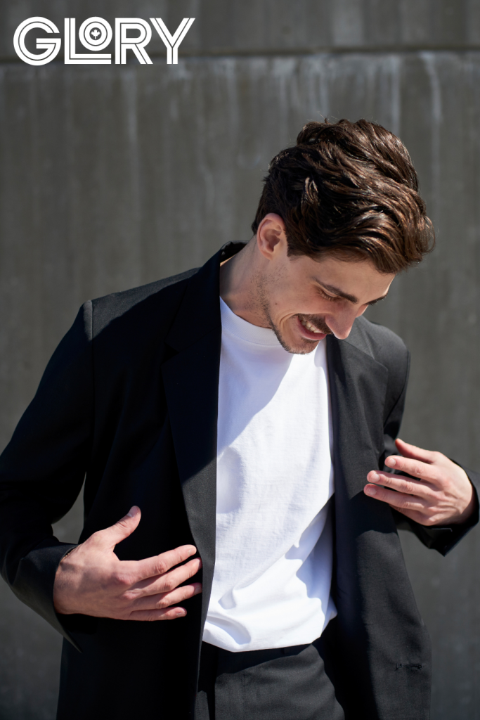 Paul Poirier in black jacket with white tee laughing